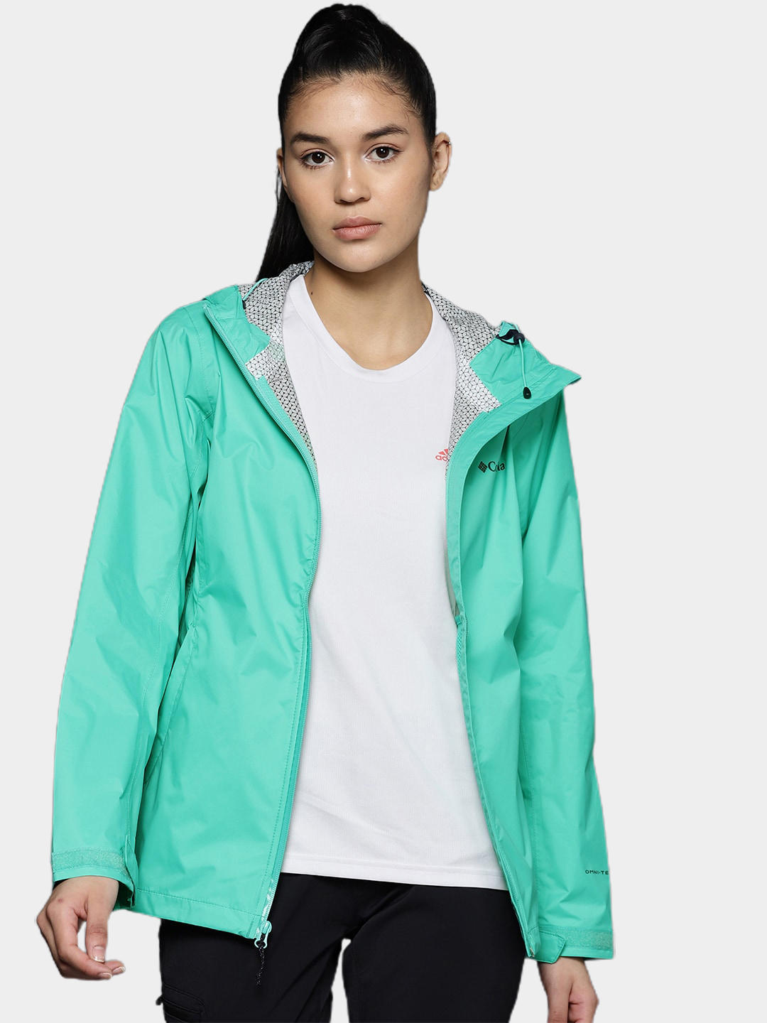 A Women Wearing Columbia Women Green EvaPOURation Jacket Waterproof