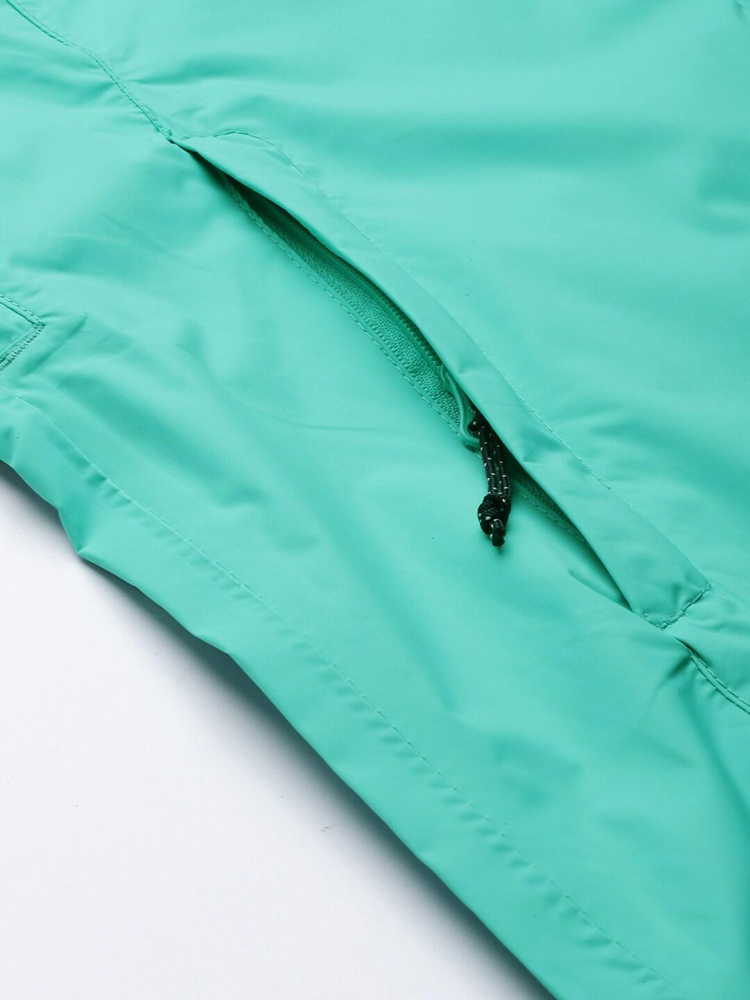 A Women Wearing Columbia Women Green EvaPOURation Jacket Waterproof