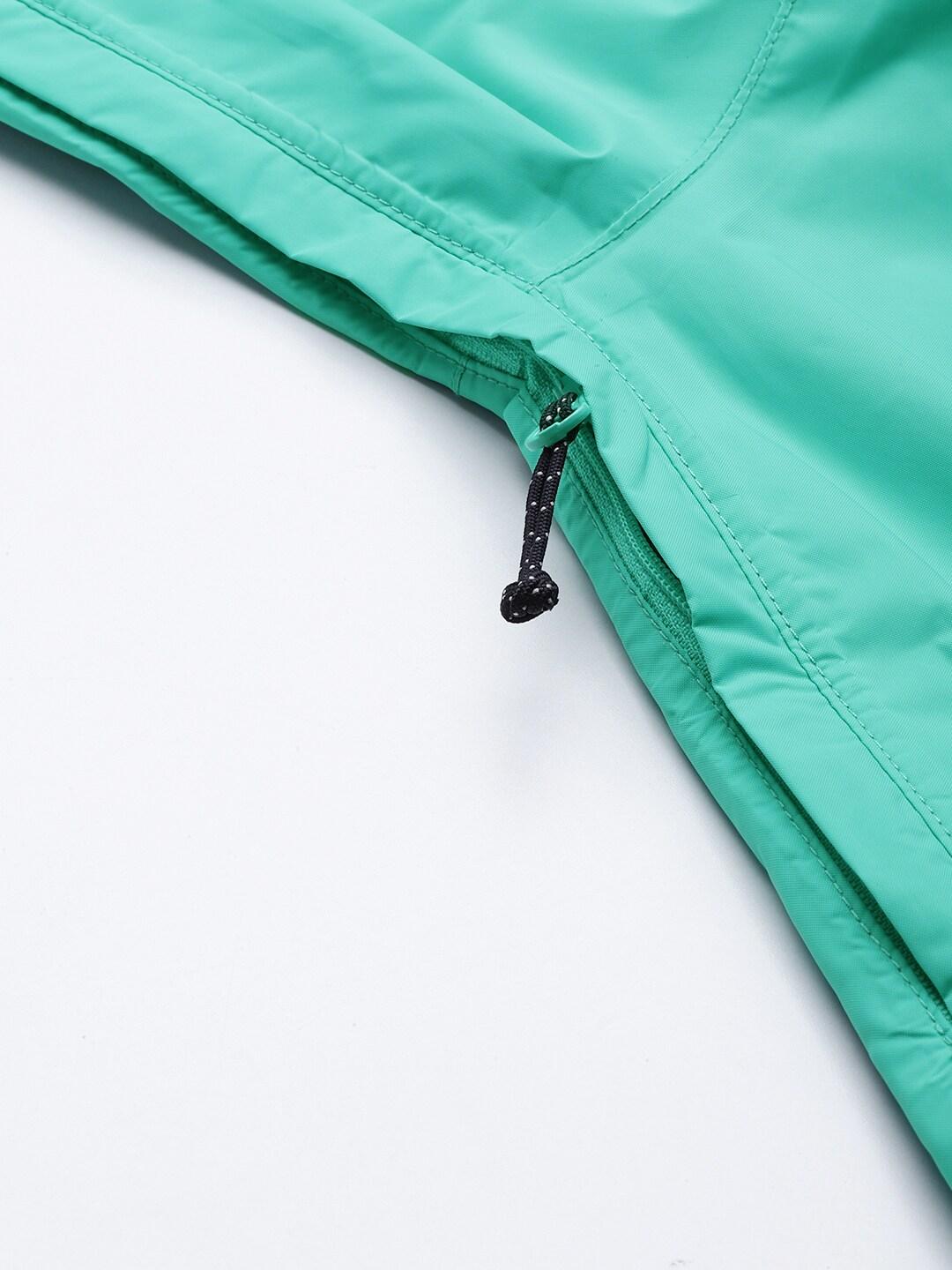 A Women Wearing Columbia Women Green EvaPOURation Jacket Waterproof
