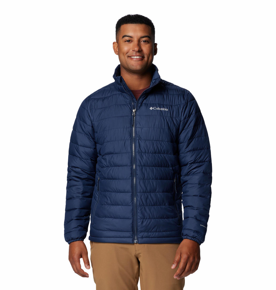 A man wearing a blue Columbia Men's Omni-Heat Reflective Powder Lite II Jacket with zippered pockets and adjustable cuffs.